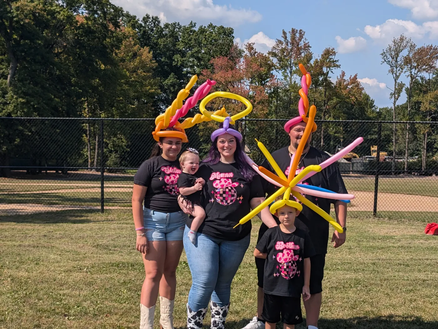 Guests showing their balloon creations outdoors