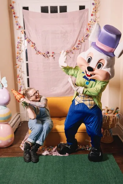 A child reaching toward an Easter Bunny mascot