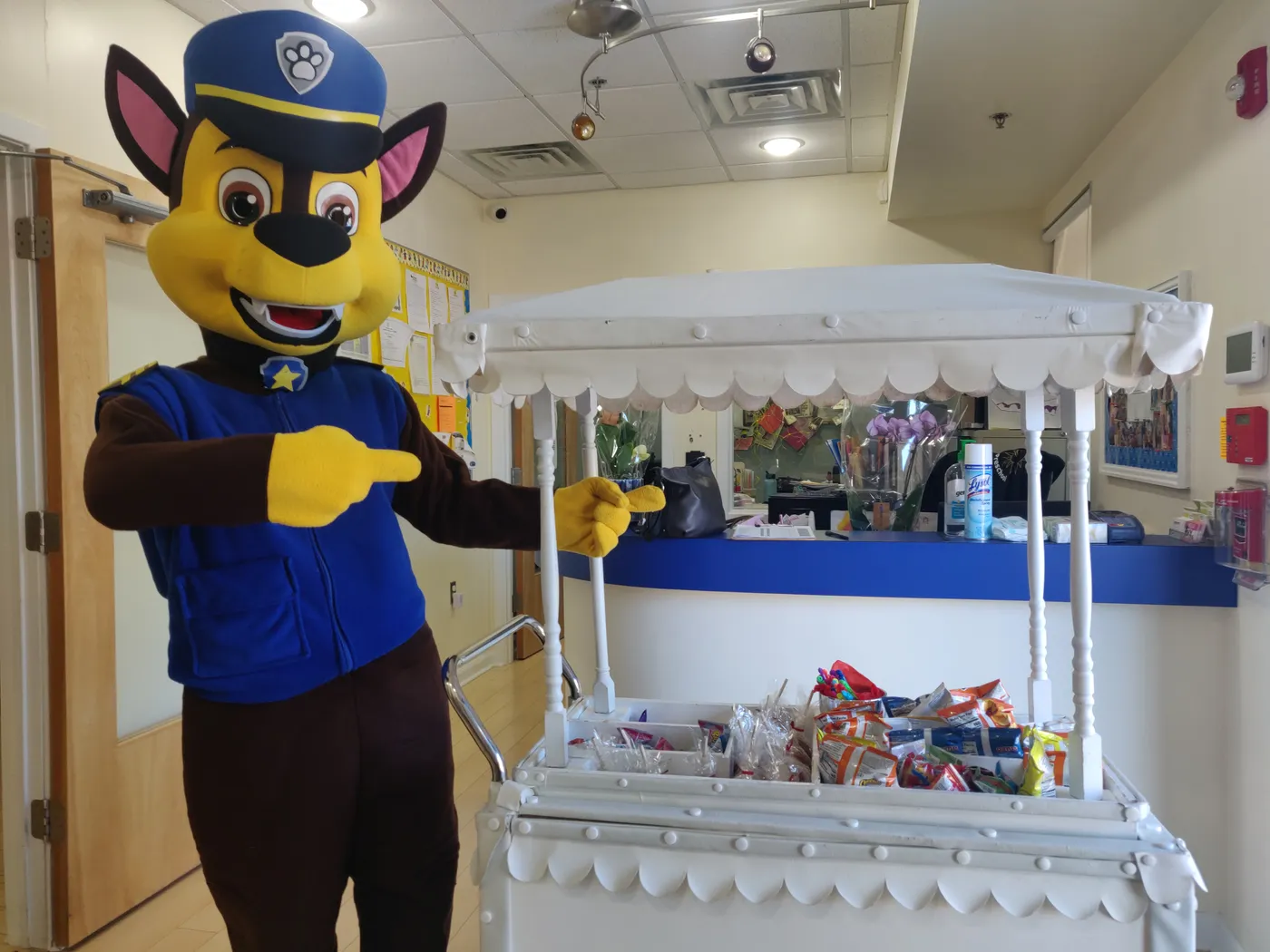 A police puppy mascot at an indoor party