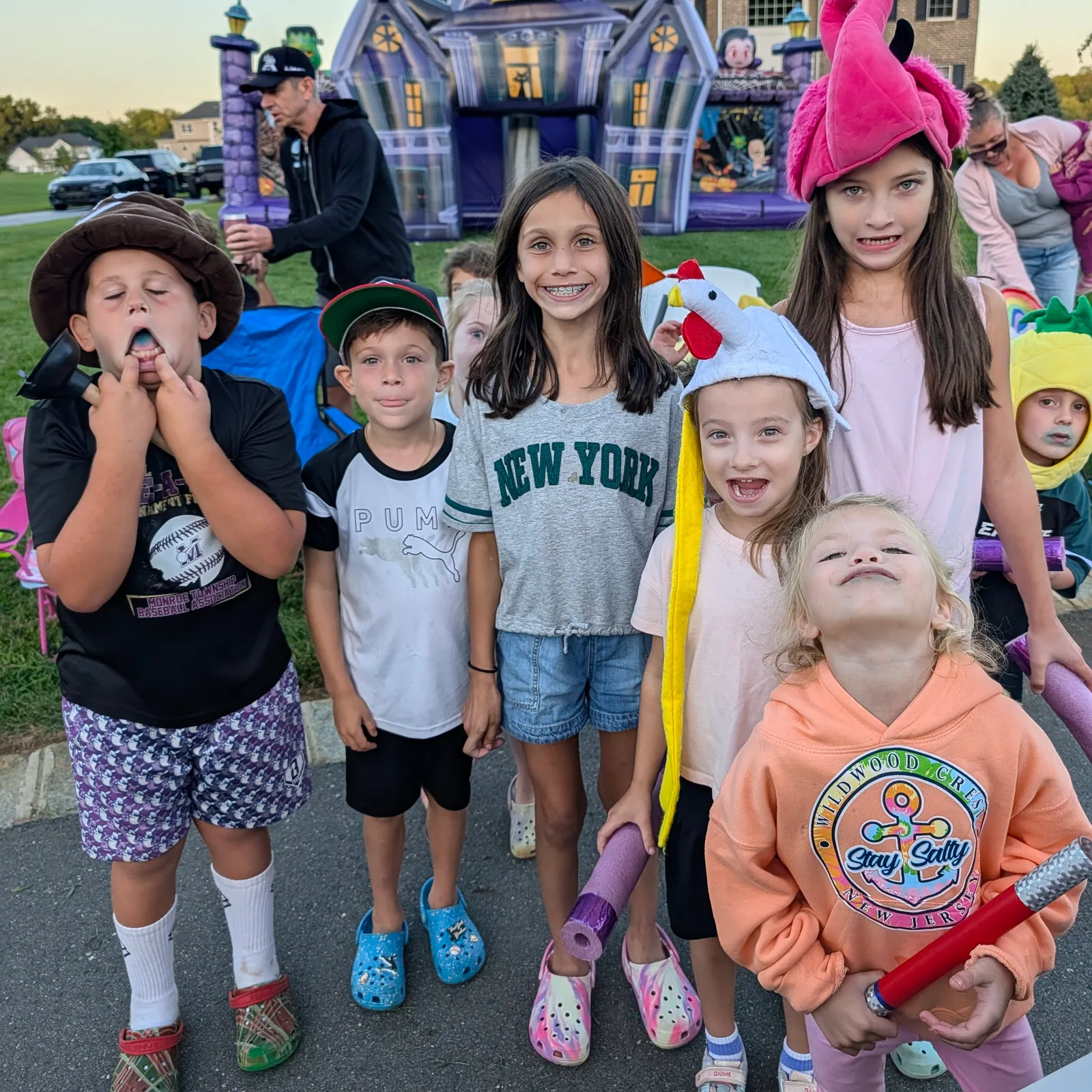 Children posing together in colorful show hats