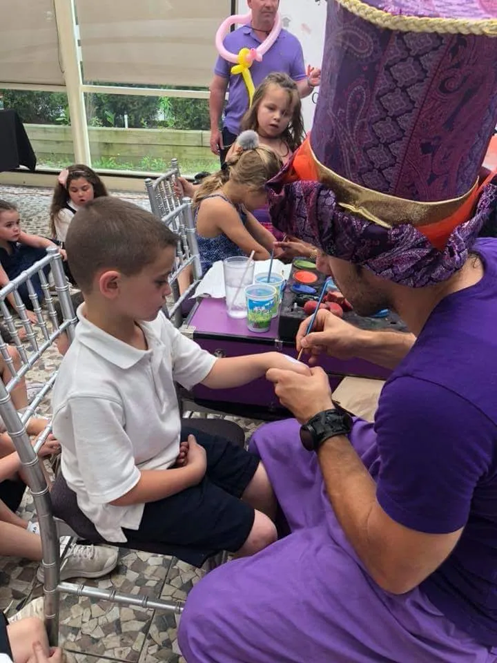 Children interacting with a magician during a show