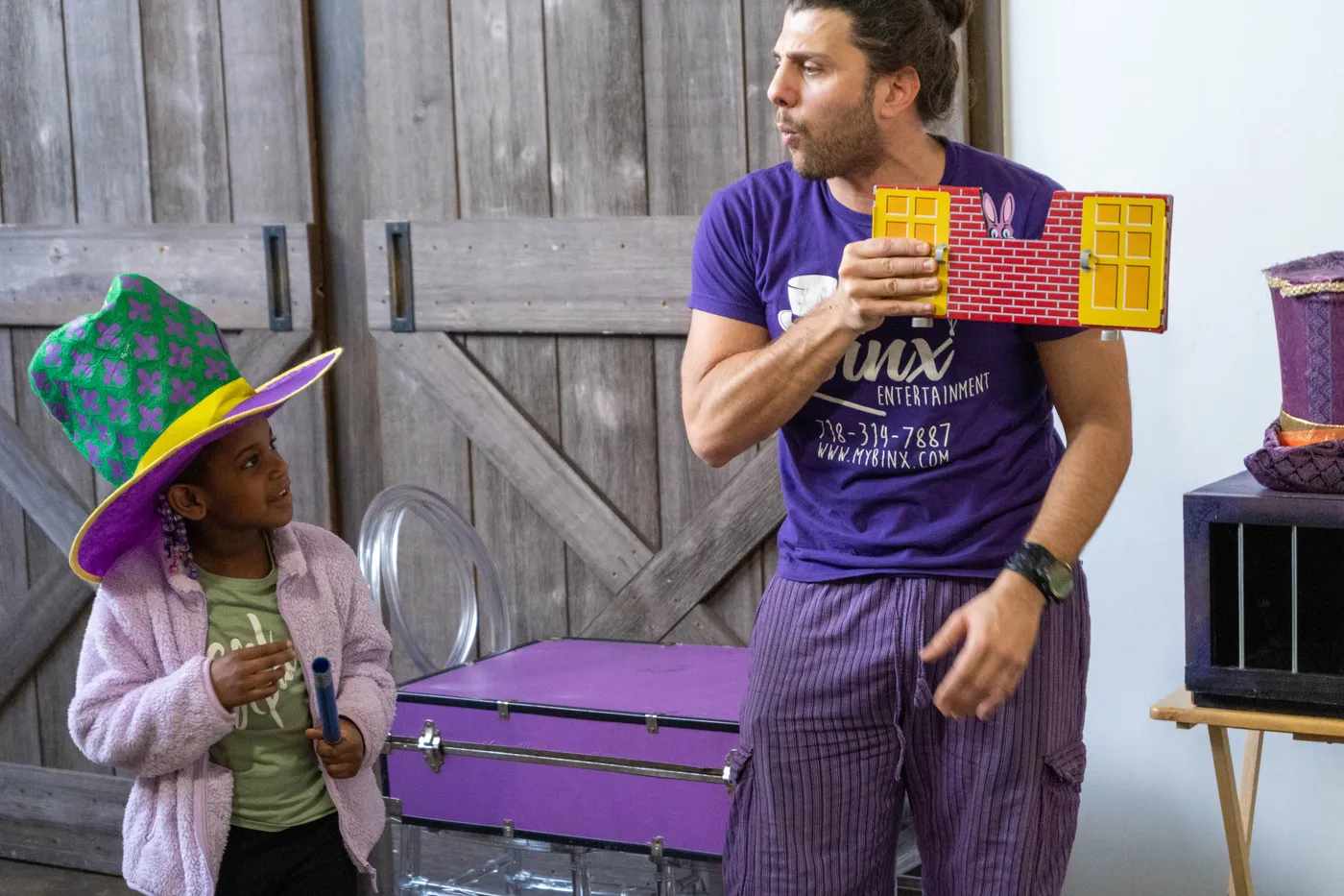 A magician showing a colorful prop during a party