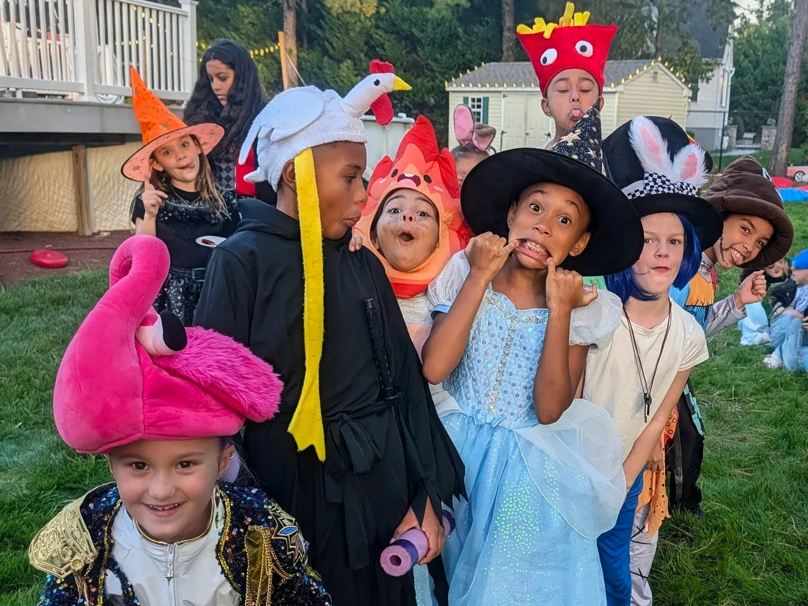Children wearing tall colorful hats outdoors