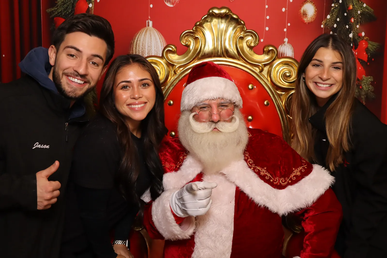 A family posing together with Santa